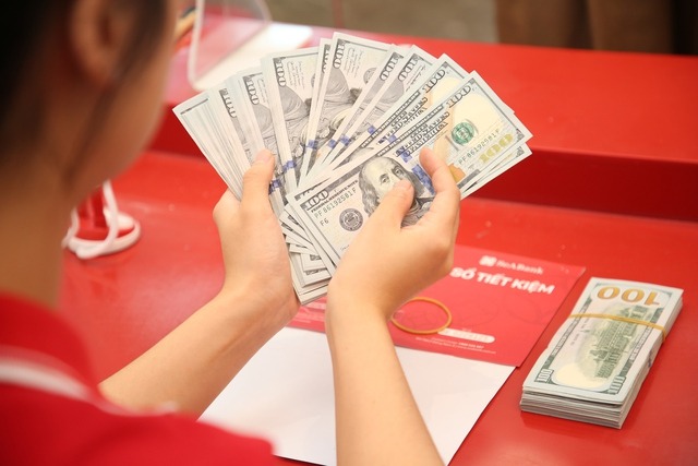 U.S. dollar bank notes in a transaction at SeABank in Vietnam. Photo courtesy of Thanh Nien (Young People) newspaper.