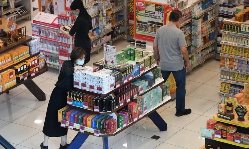  People shop at a supermarket in Singapore. Photo courtesy of AFP.