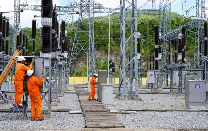 Vietnam Electricity workers examine a power station. Photo courtesy of the state utility.