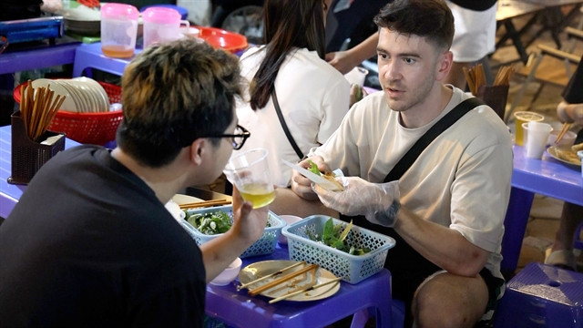  There is always time for food and camaraderie.  Photo courtesy of Vietnam News.