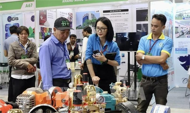People are at a display booth at the Agri Vietnam 2024. Photo courtesy of Vietnam News Agency.
