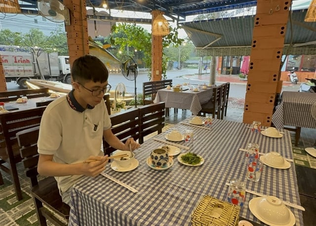 Visitor Nguyen Tian Tai from Hanoi enjoys the dish. Photo courtesy of Vietnam News.