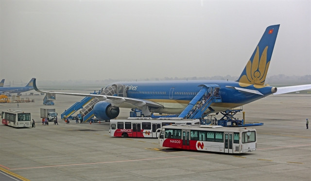 Planes of Vietnam Airlines land at Noi Bai International Airport in Hanoi. Photo courtesy of Vietnam News Agency.