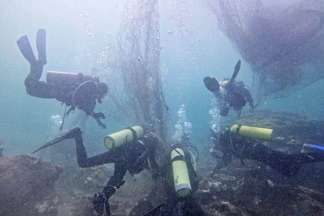 Divers remove fishing nets underwater from Brunei's coastline. Photo courtesy of borneobulletin.com.bn
