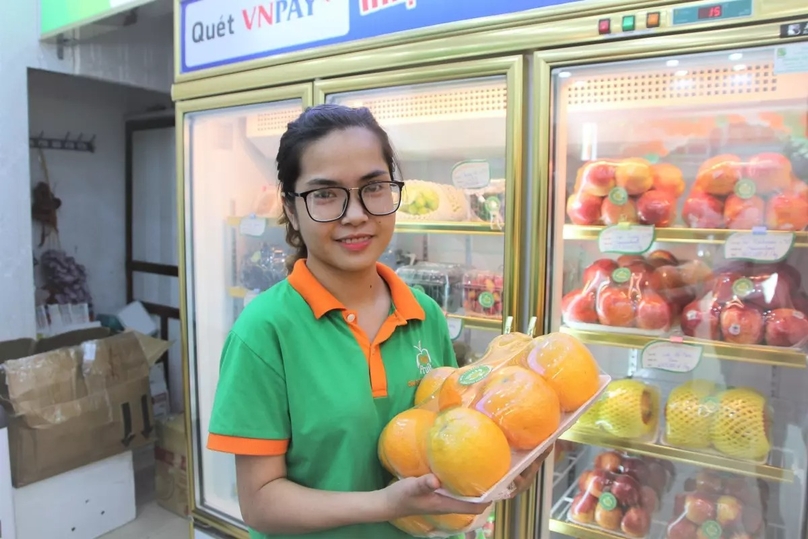  A sales person of imported fruits. Photo courtesy of Hanoi-based Fuji Fruit.