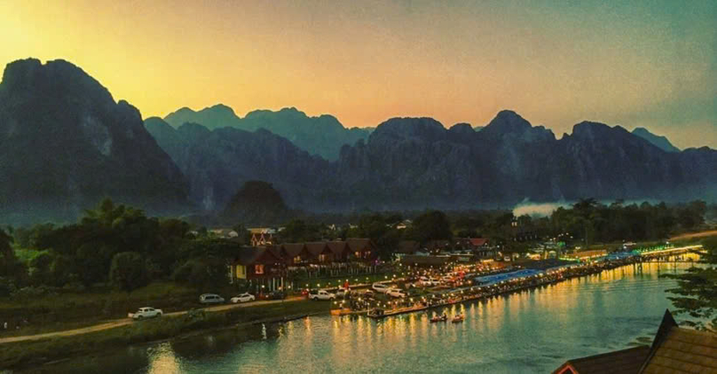 Vang Vieng is a town in the Lao province of Vientiane, about halfway to Luang Prabang, known for its picturesque views, limestone cliffs and caves. Photo courtesy of laotiantimes.com.