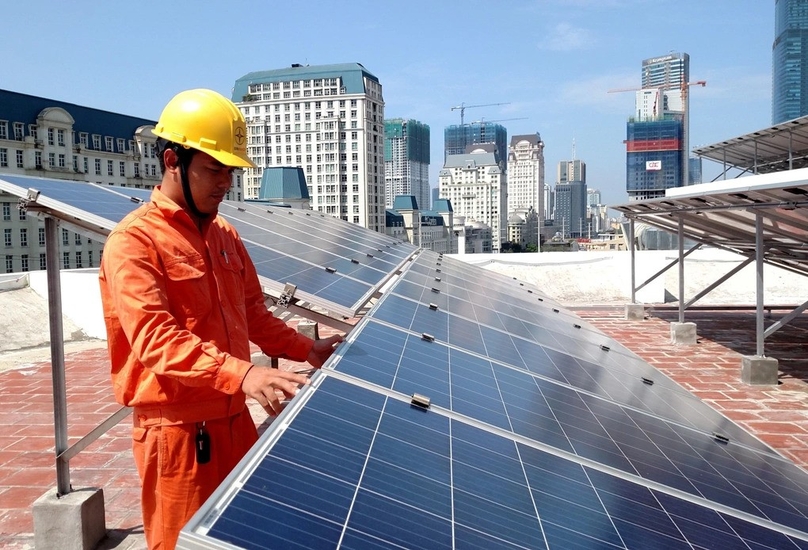  An EVN employee works on a rooftop solar power system. Photo courtesy of EVN.