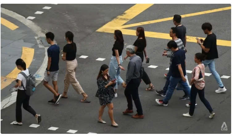 People crossing the street at the central business district (CBD) in Singapore. Photo courtesy of channelnewsasia.com.