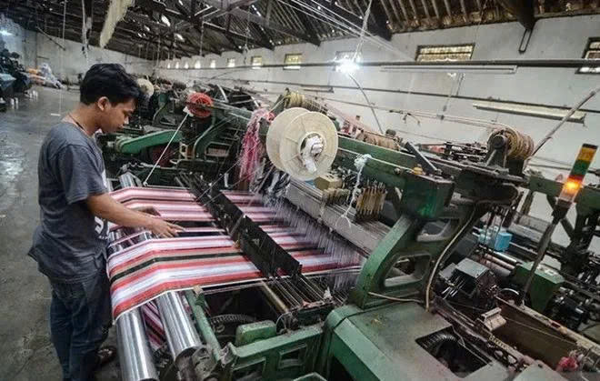  A worker completes production of sarong cloth in a textile factory in Majalaya industrial estate in Bandung regency, West Java. Photo courtesy of Antara.