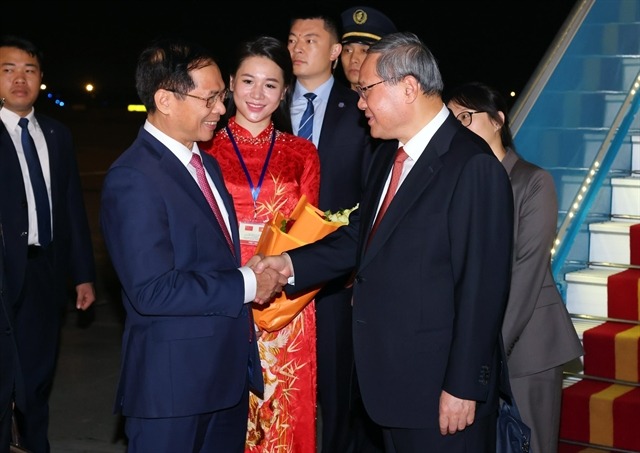 Chinese Premier Li Qiang (right) is welcomed at Noi Bai international airport in Hanoi on October 12, 2024. Photo by Vietnam News Agency.