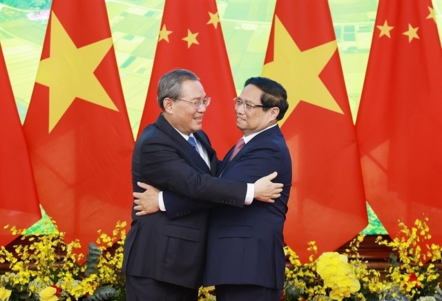 Prime Minister Pham Minh Chinh greets Chinese Premier Li Qiang on October 13, 2024. Photo courtesy of Vietnam News Agency.