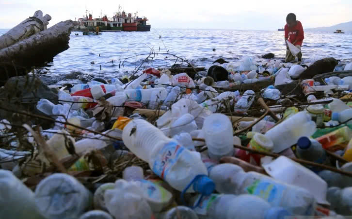 A boy collects plastic waste scattered on a beach in Ternate, North Maluku province of Indonesia. Photo courtesy of Antara.