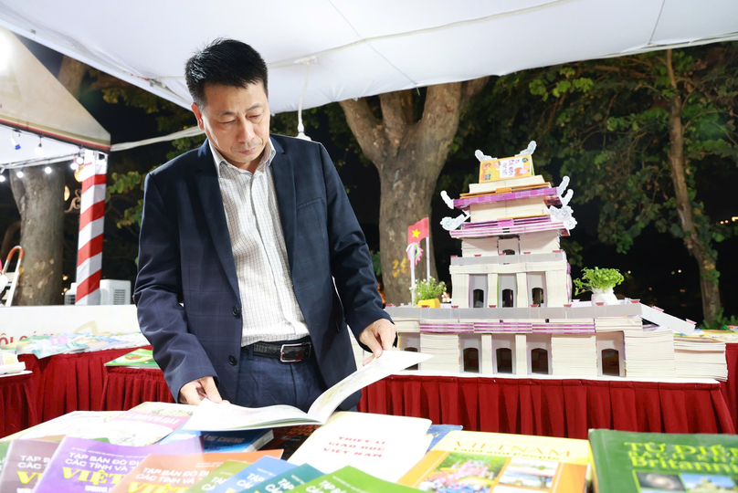 Editor-in-chief Pham Vinh Thai at the booth of Vietnam Education Publishing House. Photo by The Investor/Thuc Anh.