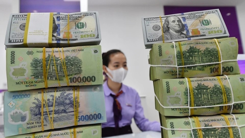 Vietnam dong and U.S. dollar bundles at a bank in Vietnam. Photo courtesy of Znews.vn.