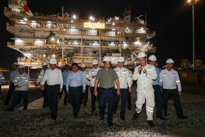 Prime Minister Pham Minh Chinh (green shirt) visits an offshore windfarm foundation made by PTSC. Photo courtesy of Petrovietnam.