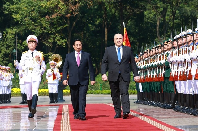 Vietnamese Prime Minister Pham Minh Chinh (left) and Russian counterpart Mikhail Vladimirovich Mishustin review the guards of honor at the official welcome ceremony in Hanoi on January 14. Photo courtesy of Vietnam News Agency.