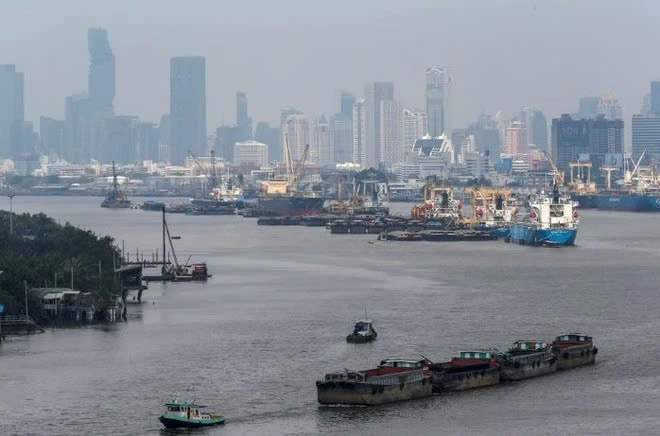 Cargo vessels move near a port in Bangkok, Thailand. Photo courtesy of Reuters/VNA.