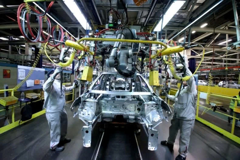 Workers on an electric vehicle production line. Photo courtesy of Bangkokpost.