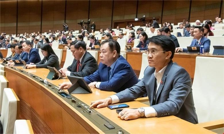 National Assembly delegates press the voting buttons to pass a resolution that sets Vietnam's GDP growth rate at 8% or more. Photo courtesy of the National Assembly.