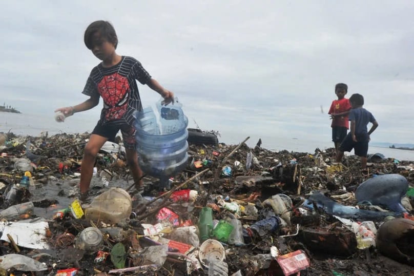 Children collect trash on July 9, 2020 at Muaro Lasak Beach, Padang, West Sumatra. Photo courtesy of Antara.