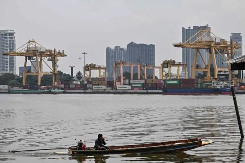 A boatman docks on the Samut Prakan side in front of Bangkok Port along the Chao Praya River in Samut Prakan province on April 8, 2025. Photo courtesy of AFP/Bangkok Post.