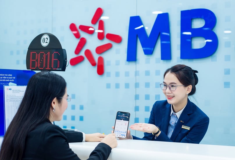 An MB staff is introducing the bank's products to a customer. Photo courtesy of the bank.