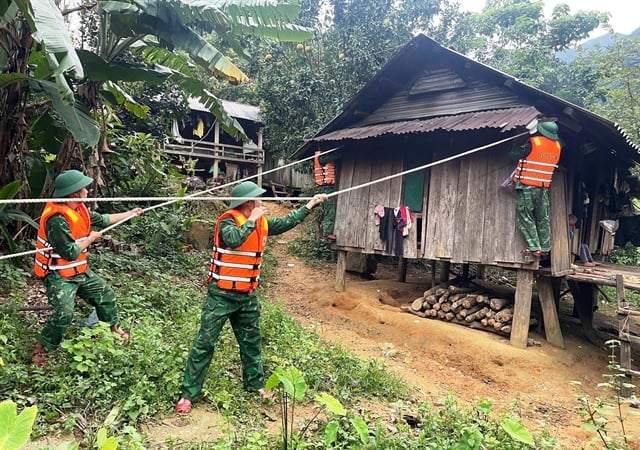 Border guards in Quang Tri province help residents reinforce their homes and secure belongings ahead of typhoon Kajiki.