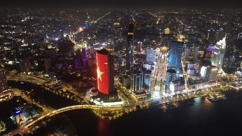An aerial view of Ho Chi Minh City by the Saigon River will illuminated skyscrappers. Photo courtesy of VNA.