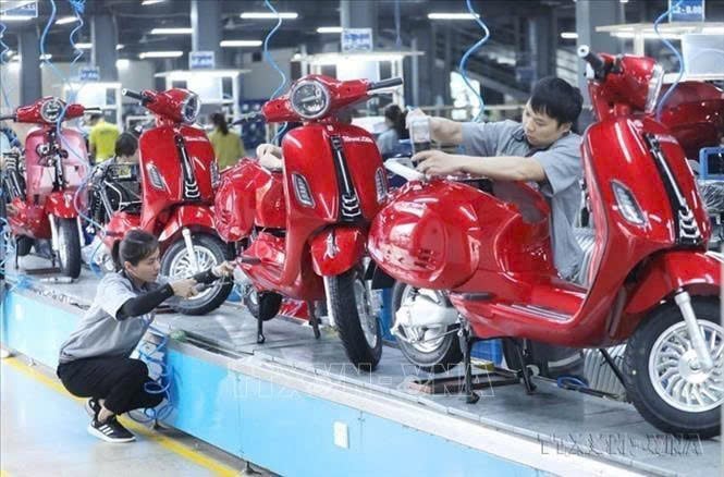 Workers check e-motorbikes. Photo courtesy of Vietnam News Agency.