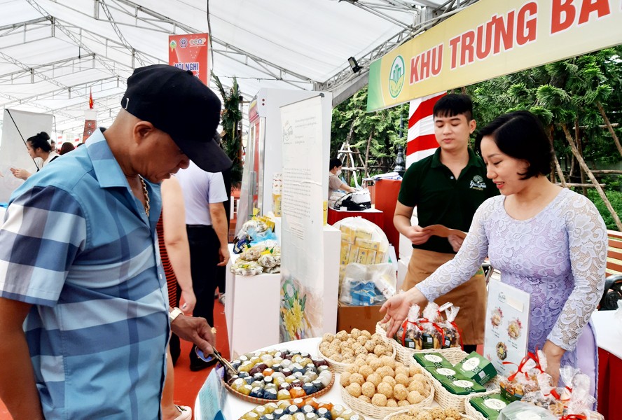 Người dân tham quan, mua sắm các sản phẩm OCOP tại hội chợ. Ảnh: Hà Nội Mới