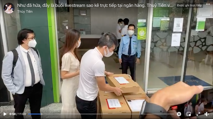 Chiều 17-9, vợ chồng ca sĩ Thủy Tiên - Công Vinh đã thực hiện sao kê tài khoản ngân hàng để minh bạch khoản tiền kêu gọi ủng hộ bà con miền Trung mùa lũ. Ảnh chụp từ clip: Thủy Tiên- Công Vinh và phía luật sư livestream ngay bên ngoài ngân hàng.