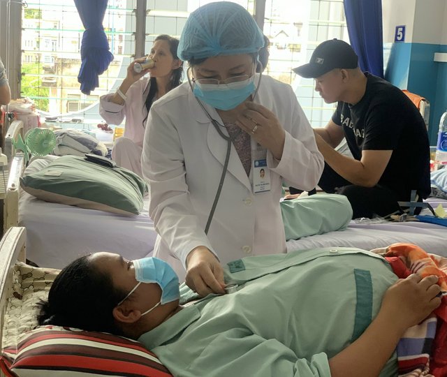  TS.BS Nguyễn Thị Cẩm Hường thăm khám cho một bệnh nhân là thai phụ mắc sốt xuất huyết.