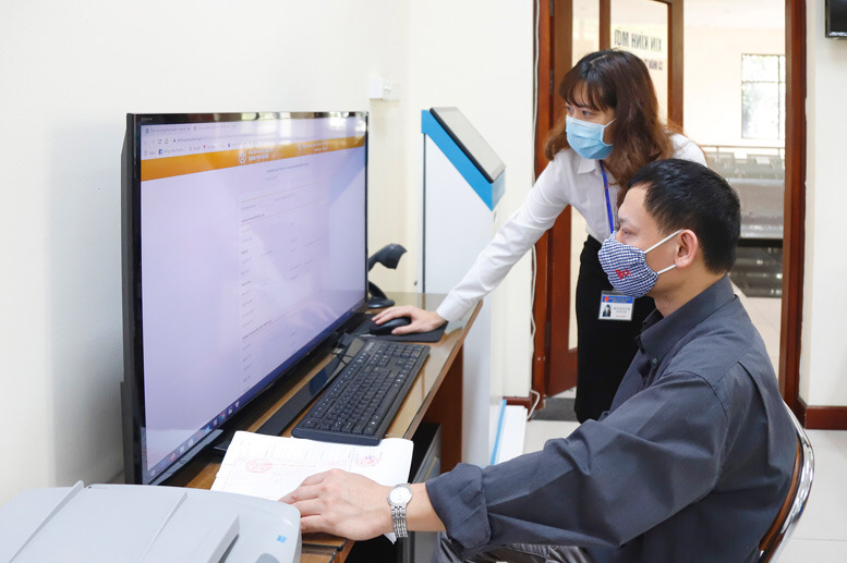 Hướng dẫn người dân làm thủ tục dịch vụ công trực tuyến tại bộ phận “một cửa” của UBND quận Hai Bà Trưng.