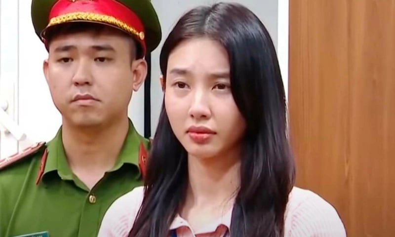 Hoa hậu Thùy Tiên (phải) khi nghe cảnh sát đọc lệnh khởi tố, bắt tạm giam. Ảnh: Bộ Công an