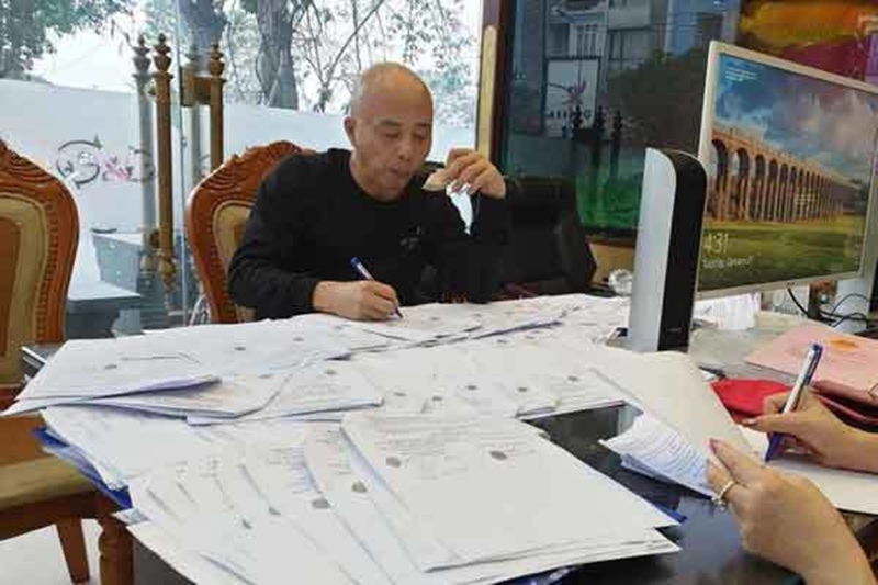 Nguyễn Xuân Đường và đống giấy tờ rao bán đất được đăng tải trên Facebook.