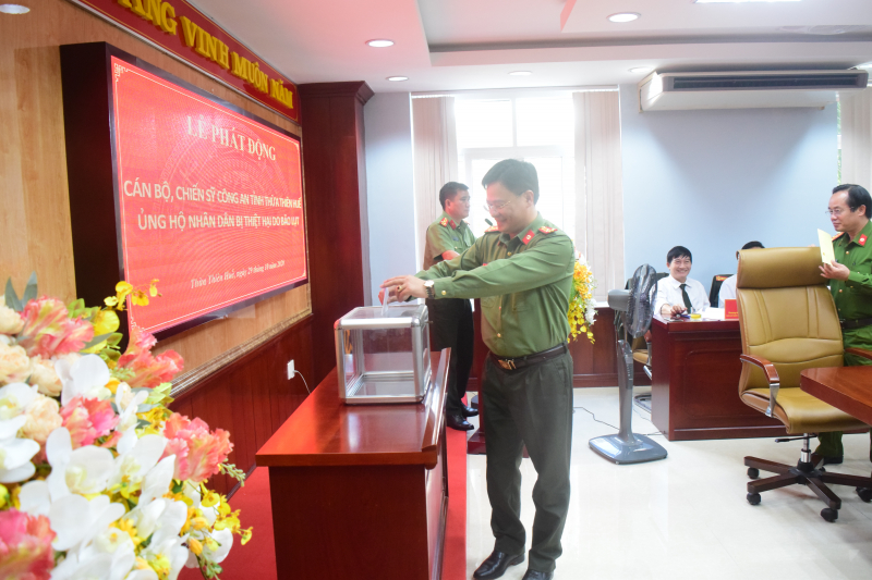 Thượng tá Nguyễn Thanh Tuấn - Giám đốc Công an tỉnh Thừa Thiên Huế - ủng hộ đồng bào bị bão lụt.