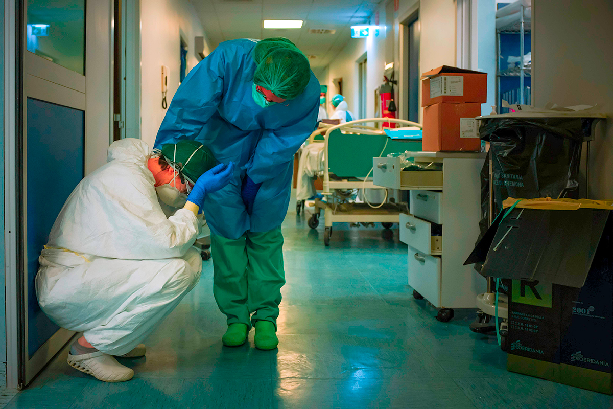 Tình hình dịch bệnh ngày 13/4: Một y tá an ủi người khác khi họ thay ca vào ngày 13/3 tại bệnh viện Cremona, phía Đông Nam Milan, Italy.