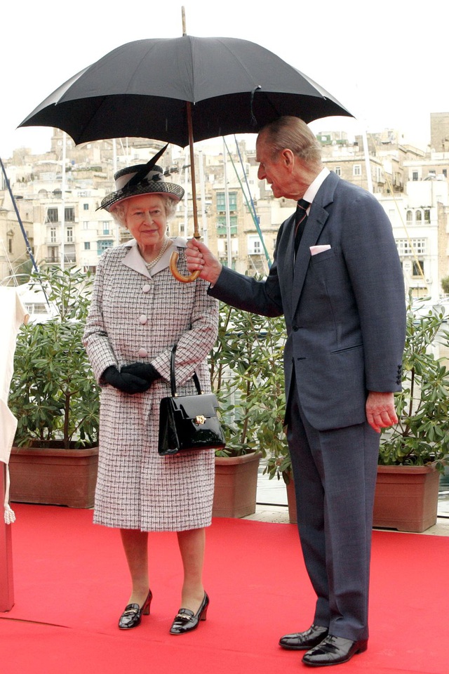  2005: Hoàng thân Philip che ô cho Nữ hoàng Elizabeth II tại một sự kiện ở Malta.