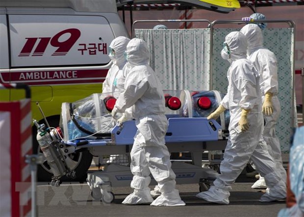 Nhân viên y tế chuyển bệnh nhân nhiễm COVID-19 tới bệnh viện ở Daegu, Hàn Quốc. (Ảnh: THX/TTXVN)