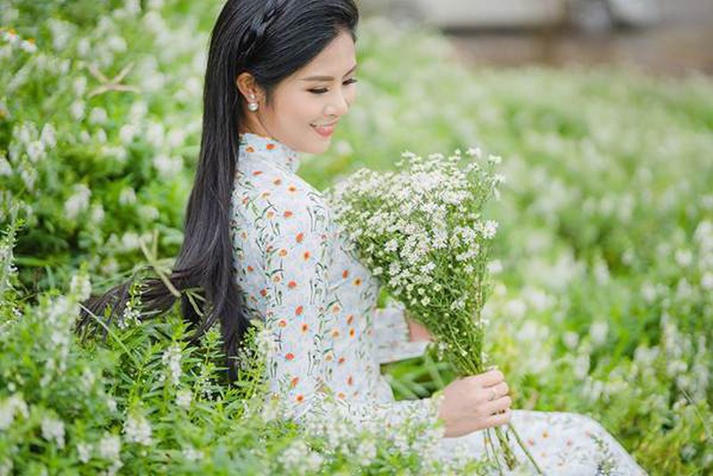 Diện những thiết kế áo dài được in hoạ tiết cúc hoạ mi nổi bật, Hoa hậuNgọc Hân hoá thành một nàng thơ duyên dáng giữa vườn hoa ngát hương.