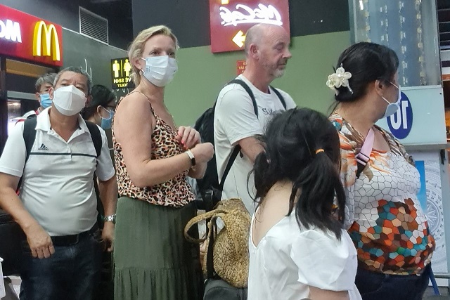Khách nước ngoài mệt mỏi chờ taxi ở sân bay Tân Sơn Nhất
