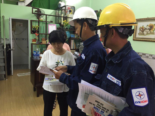 Công nhân EVNHCMC tuyên truyền sử dụng điện an toàn, tiết kiệm cho khách hàng
