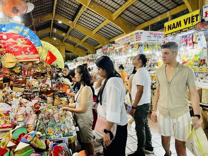 Khách quốc tế chọn mua quà lưu niệm tại chợ Bến Thành, TPHCM