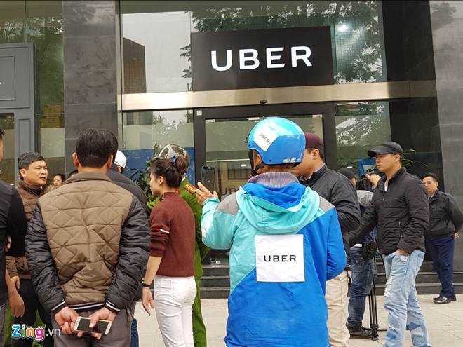 Nhiều tài xế là đối tác của Uber tập trung trước cửa văn phòng hãng để phản đối mức chiết khấu tuy nhiên hãng đóng cửa không tiếp cho đến khi có sự xuất hiện của lực lượng công an. Ảnh: Ngô Minh. 