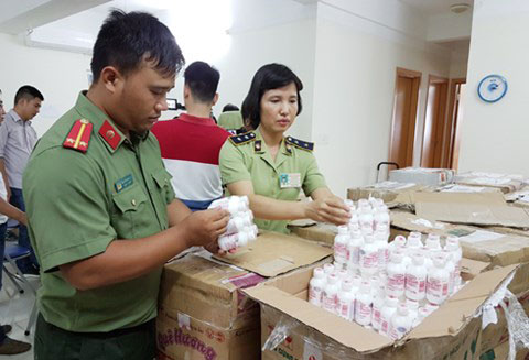 Lực lượng chức năng kiểm tra số hàng mỹ phẩm thu giữ tại quận Hà Đông.