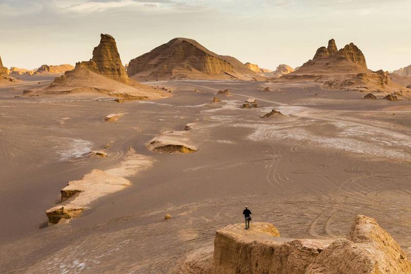 Người đàn ông đứng ở Dasht-e Lut ở Iran, một trong những nơi nóng nhất hành tinh