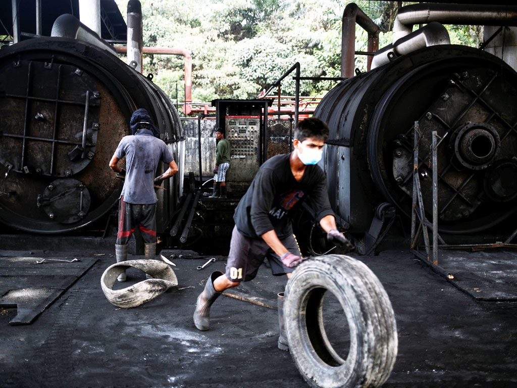 Nhiệt phân là giải pháp tối ưu để tái chế lốp xe, nhưng bản thân ngành này lại đang gây ô nhiễm môi trường. Ảnh: Công nhân làm việc với thiết bị bảo hộ thô sơ tại nhà máy nhiệt phân lốp xe ở Johor, Malaysia - Reuters