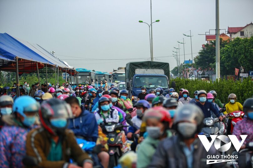 Rất đông người dân xếp hàng dài chờ đợi tại chốt kiểm soát dịch bệnh tại khu vực Cầu Giẽ (huyện Phú Xuyên, Hà Nội).