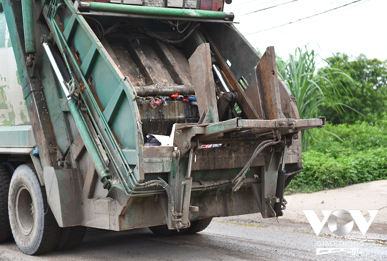 Một xe vận chuyển rác chưa được vệ sinh khi đi ra đường khiến rác thải còn bám đầy thùng xe.