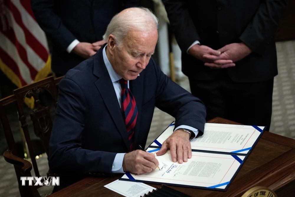 Tổng thống Mỹ Joe Biden ký một văn kiện tại Nhà Trắng, Washington, DC. (Ảnh: AFP/TTXVN)